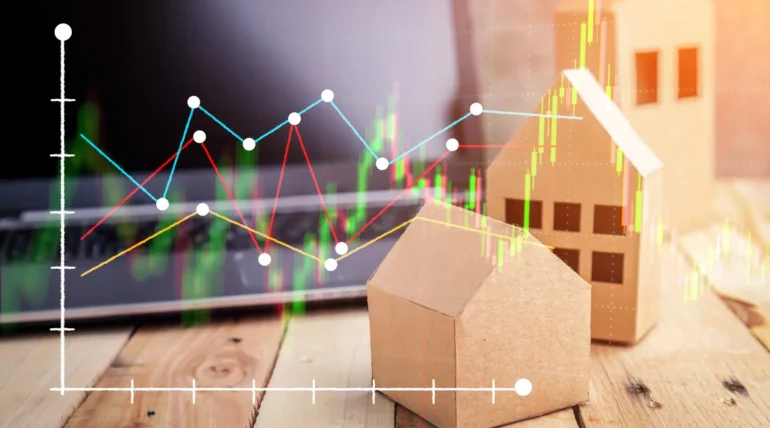 Real estate documents, keys, and a house model placed on a wooden floor, symbolizing home buying or selling process